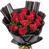 Luxury bouquet of 12 red roses wrapped in elegant black paper