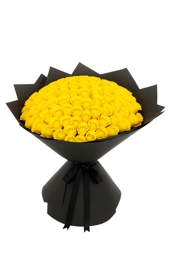 Bouquet of 100 yellow roses wrapped in black paper with a bow