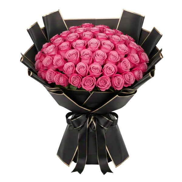 Bouquet of deep purple roses wrapped in black paper with a bow on a white background