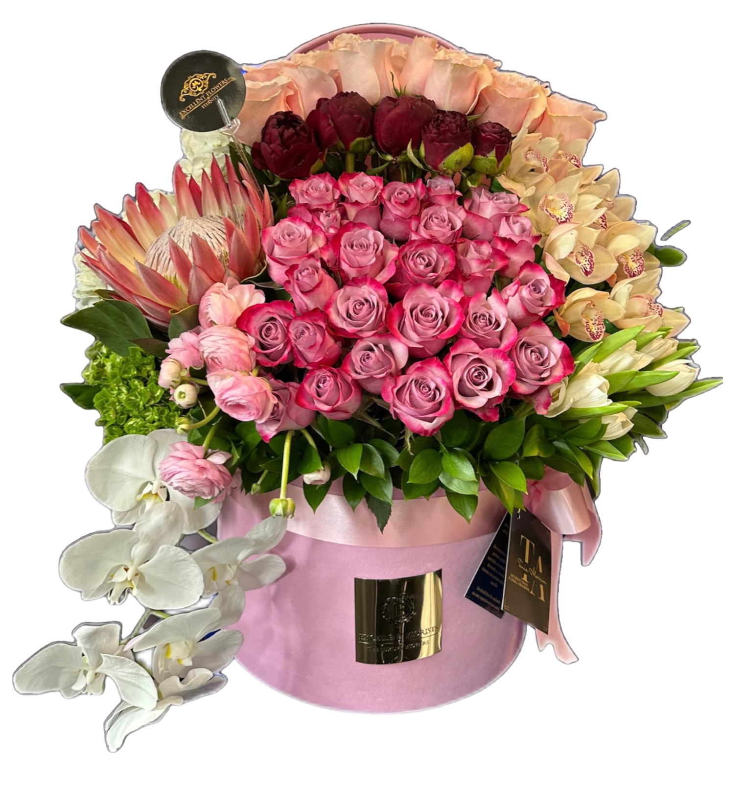 A floral arrangement featuring a mix of pink and red roses, white tulips, orchids, and green hydrangeas in a pink container.
