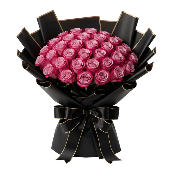 Bouquet of deep purple roses wrapped in black paper with a bow on a white background
