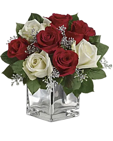 Holiday Elegance Christmas arrangement with red and white roses in a glass vase