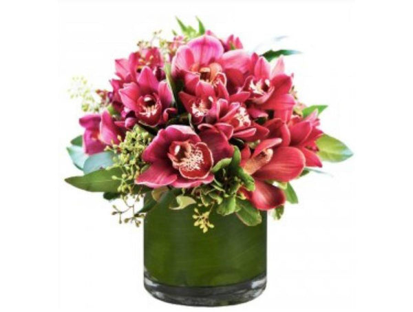 Orchid and greenery arrangement in a vase