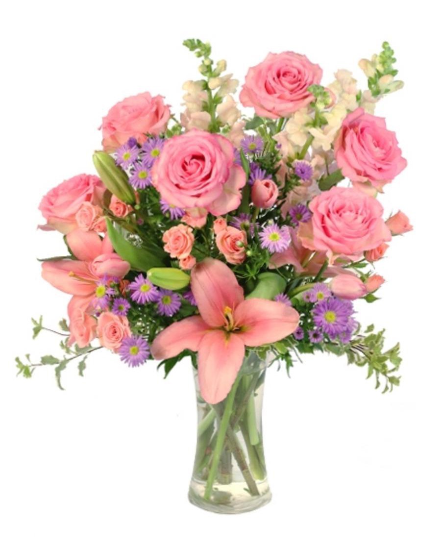 Blush pink rose arrangement with seasonal flowers in a glass vase