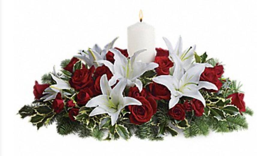 Christmas Harmony centerpiece with red roses, white lilies and festive greenery by Excellent Florists