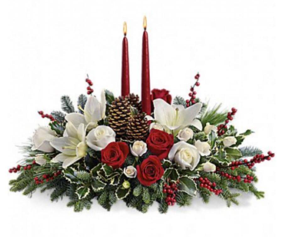 Evergreen Christmas Glow Christmas floral centerpiece with roses, lilies, pinecones, festive greenery and holiday berries
