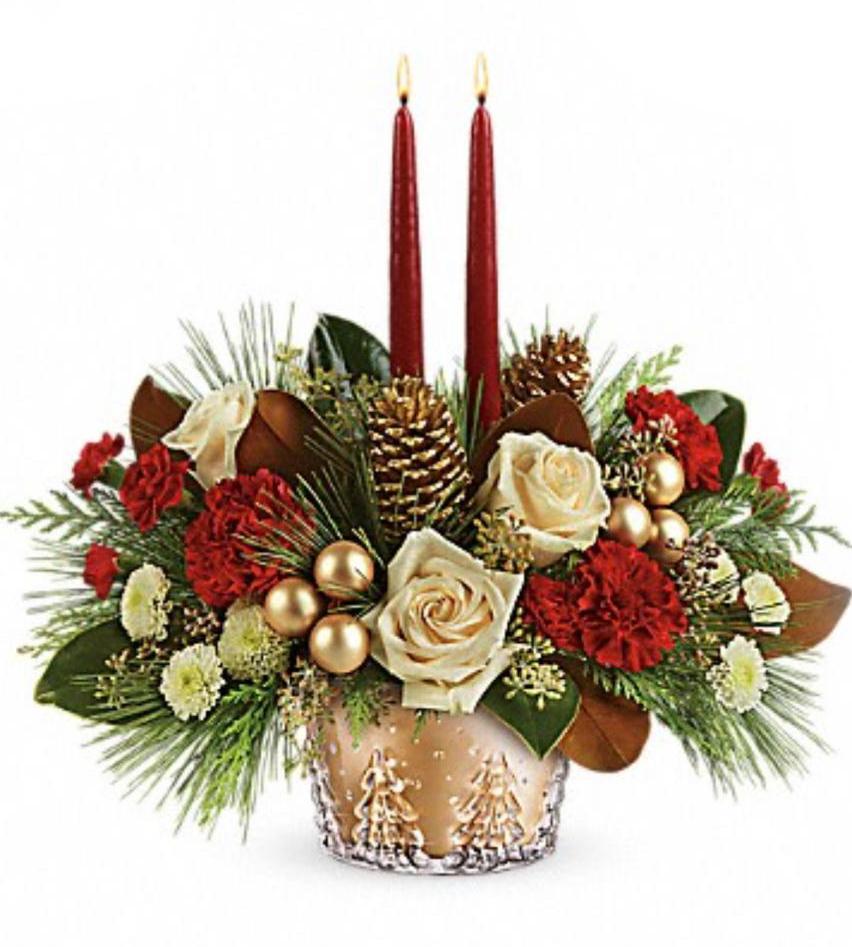 A decorative floral arrangement featuring roses, carnations, pinecones, and Christmas-themed decorations, displayed in a decorative vase.