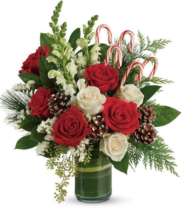 Merry Christmas Greetings floral arrangement with red and white roses, hypericum berries, pine greenery and festive Christmas accents