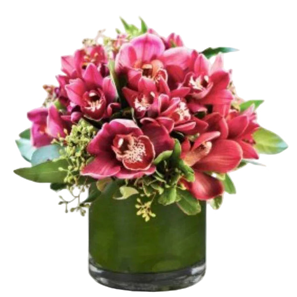 Elegant orchid and greenery arrangement in a glass vase