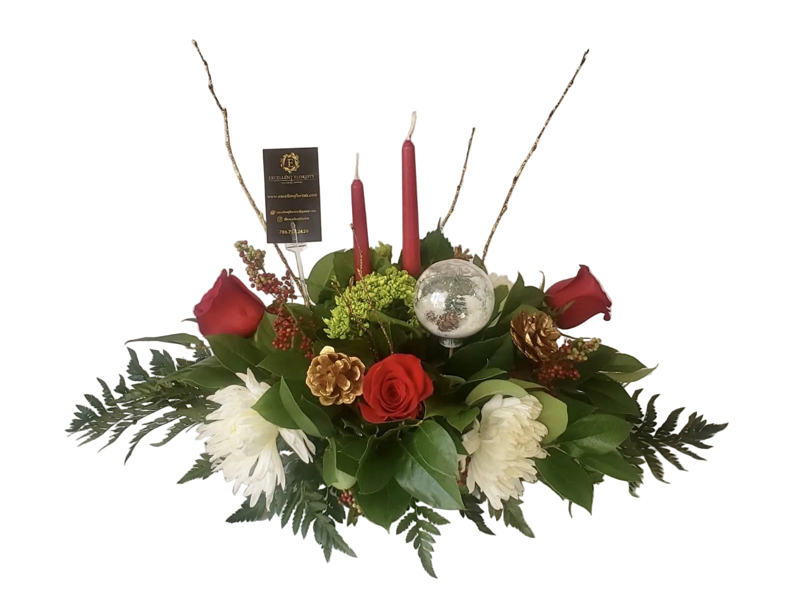 A holiday-themed floral centerpiece featuring red roses, green hydrangea, red carnations, white mums, and a gold pine ornament.