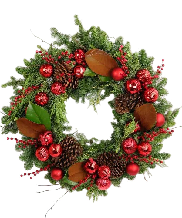 A round wreath decorated with red ornaments, red ilex berries, pinecones, and green magnolia leaves.